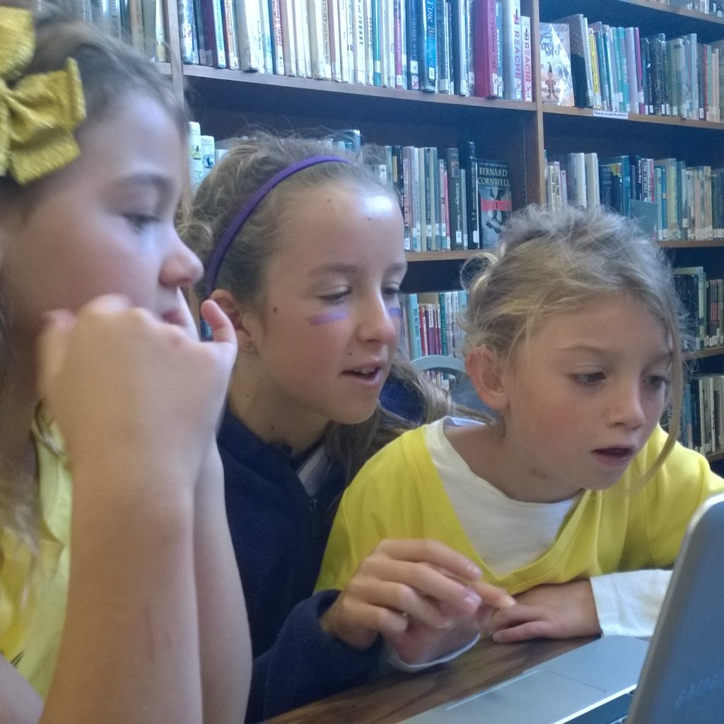 Three Girls Look And Reacting To Screen Of A Chromebook