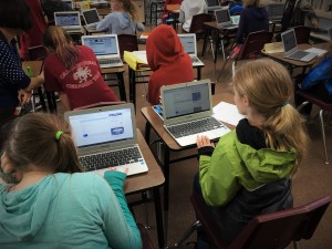 Students sitting at desks using Chromebooks in Classrooms